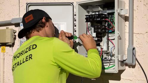 photo of an electrician fixing a breaker panel